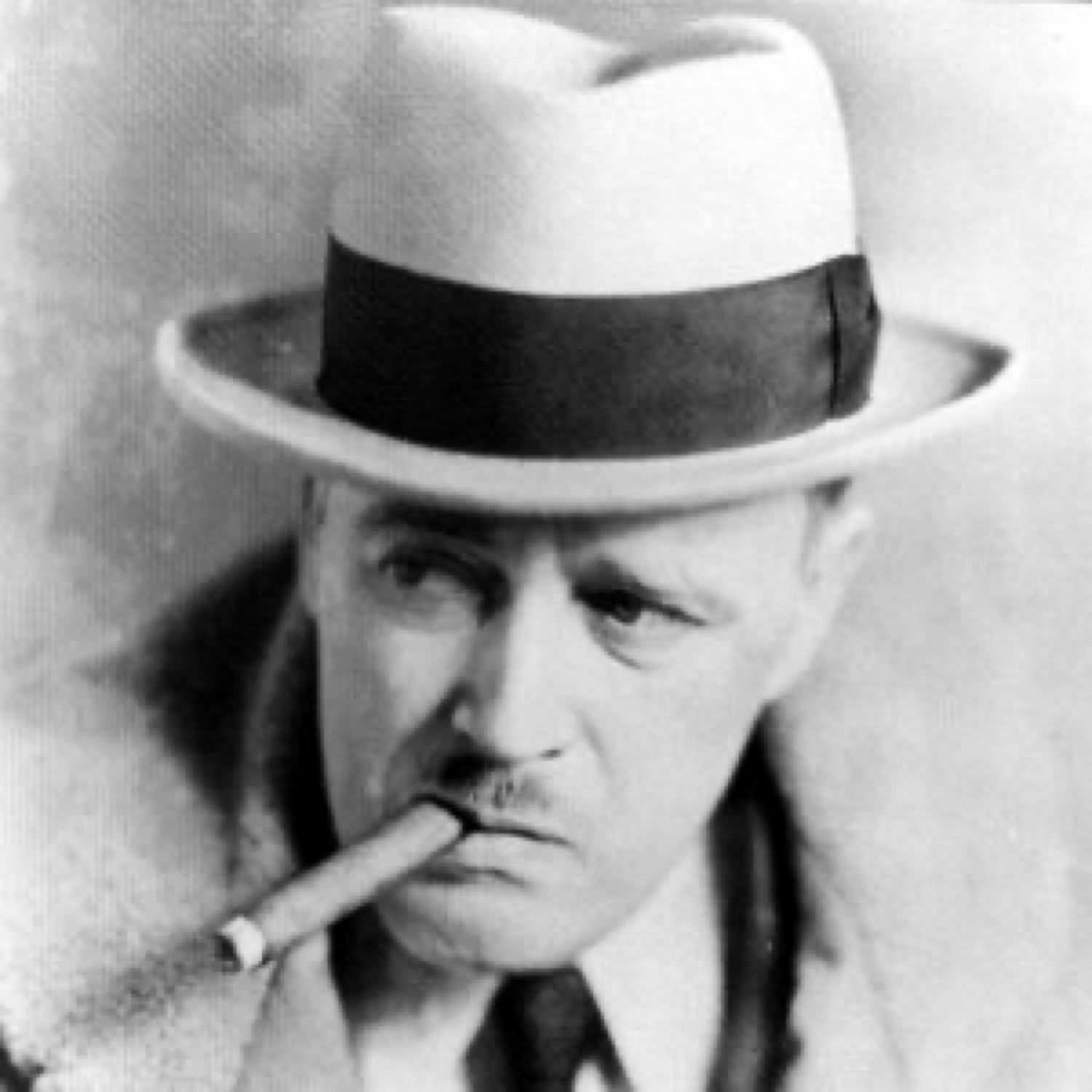 Vance Randolph in a light fedora with a dark band, cigar in his mouth